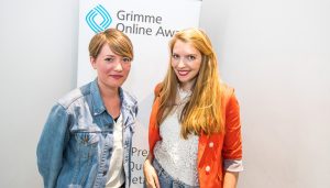 Lisa Altmeier und Steffi Fetz, Gründerinnen von "Crowdspondent", vor einem Rollup des Grimme Online Award; Foto: Rainer Keuenhof/Grimme-Institut
